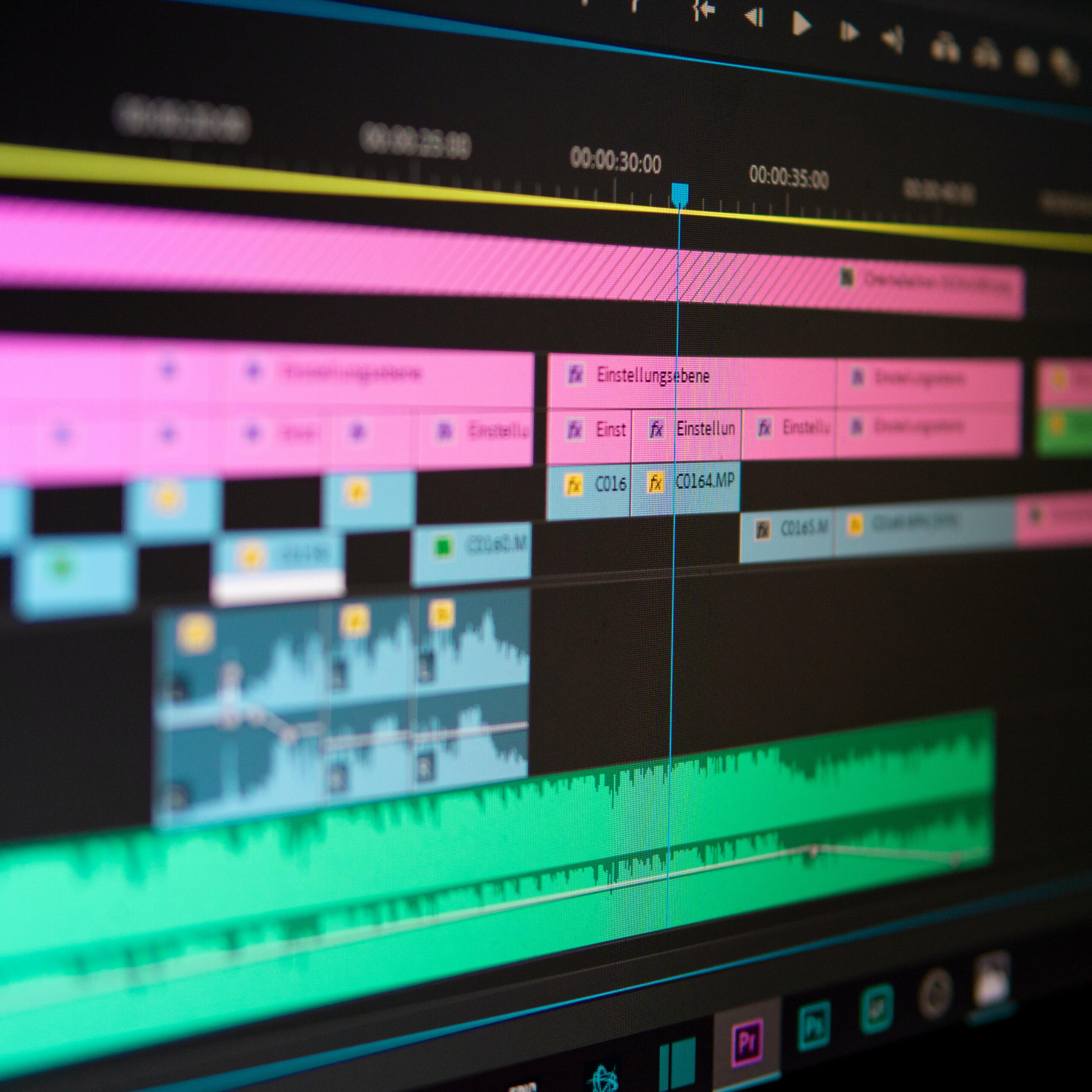 Screenshot of a video editing timeline showing different layers of video composition files and audio in pink, blue and green bars stacked on top of eachother